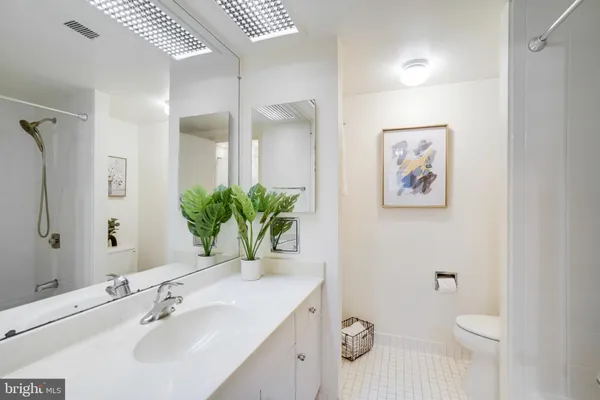 a bathroom with a sink a toilet and mirror