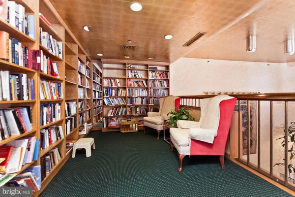 a reading room with furniture and book shelf