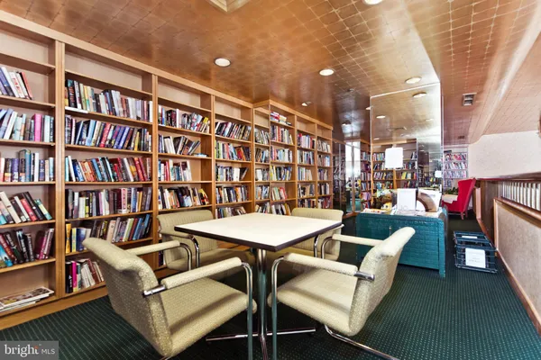 a view of a livingroom with furniture and a bookshelf