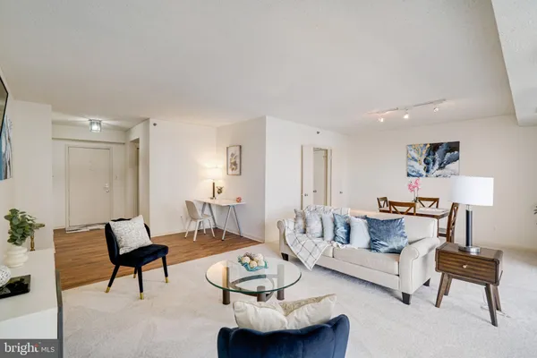 a living room with furniture and a lamp