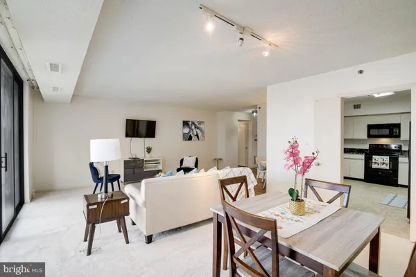 a living room with furniture and white walls
