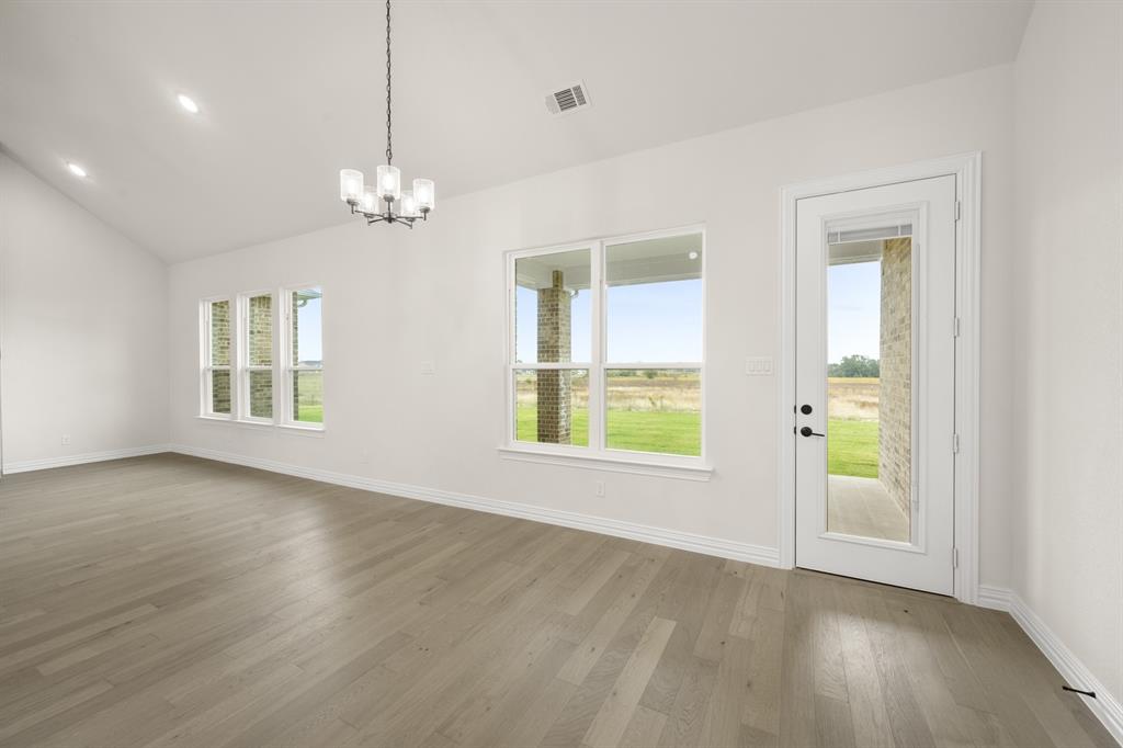 211 Marie Lane Waxahachie, TX 75167 - Photo 10 of 24 a view of an empty room with a window and wooden floor
