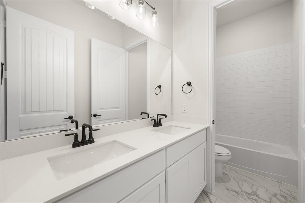 211 Marie Lane Waxahachie, TX 75167 - Photo 14 of 24 a bathroom with a sink and a mirror