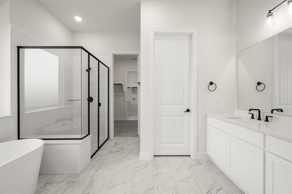 211 Marie Lane Waxahachie, TX 75167 - Photo 18 of 24 a bathroom with a bathtub and a shower