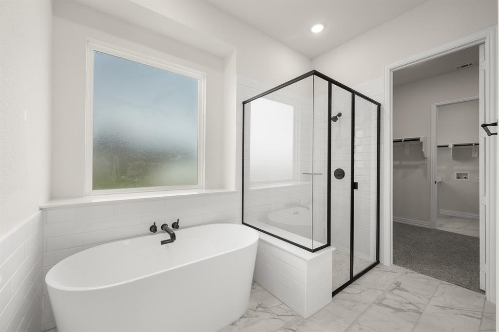 211 Marie Lane Waxahachie, TX 75167 - Photo 19 of 24 a bathroom with a bathtub and a shower