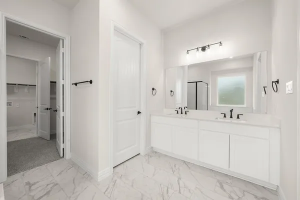 a bathroom with a double vanity sink mirror and shower