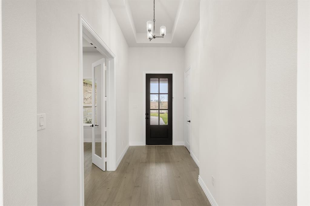 211 Marie Lane Waxahachie, TX 75167 - Photo 2 of 24 a view of a hallway with wooden floor and staircase