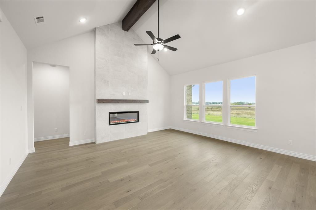 211 Marie Lane Waxahachie, TX 75167 - Photo 4 of 24 a view of an empty room with a window and wooden floor