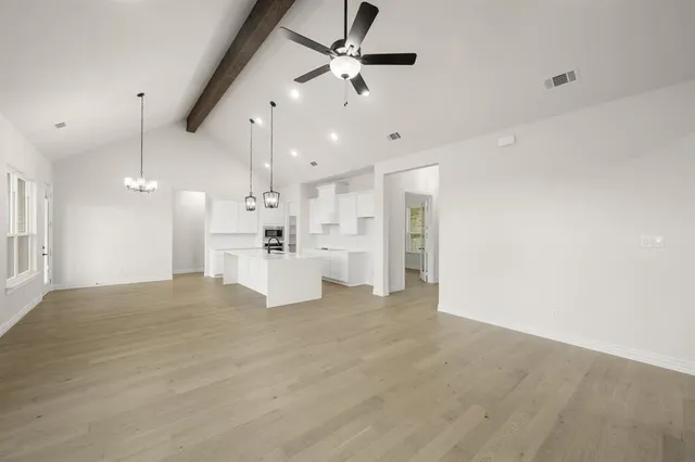 a view of a kitchen with a sink and refrigerator