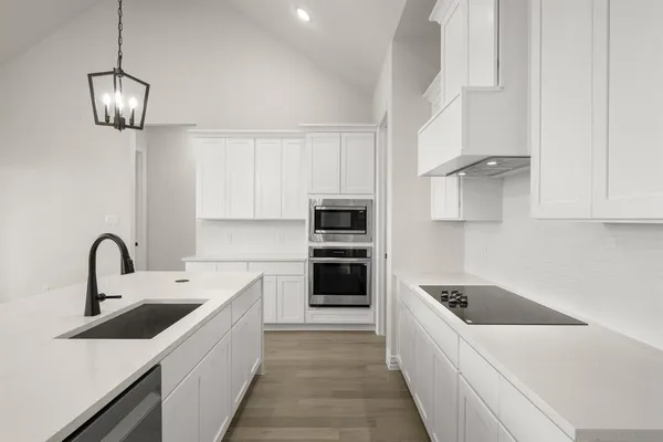 a kitchen with a sink and stainless steel appliances