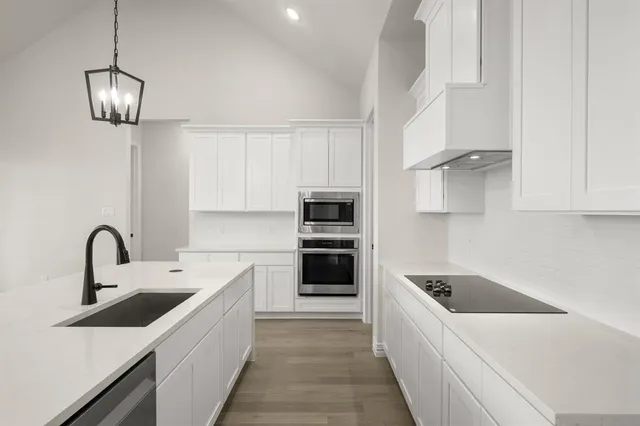 a kitchen with a sink and stainless steel appliances