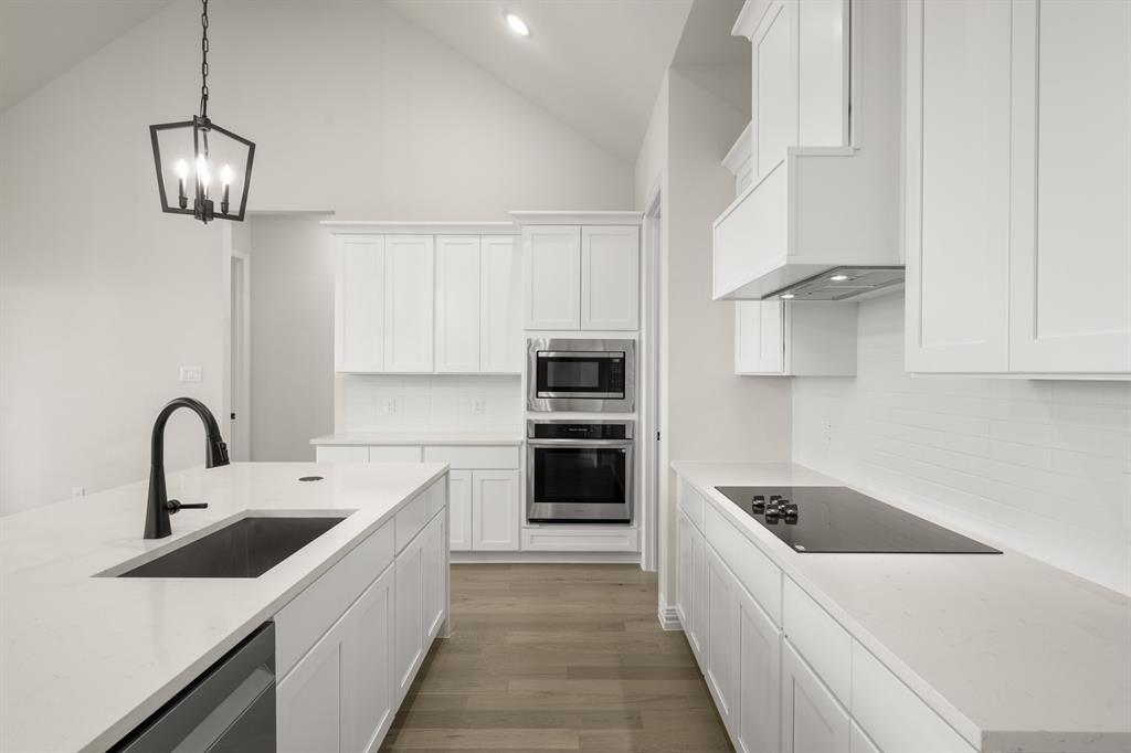 211 Marie Lane Waxahachie, TX 75167 - Photo 9 of 24 a kitchen with a sink and stainless steel appliances