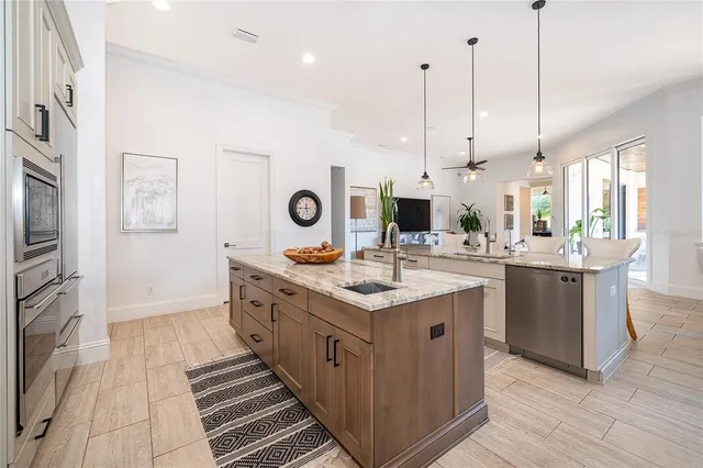 a bathroom with a granite countertop sink a toilet and shower