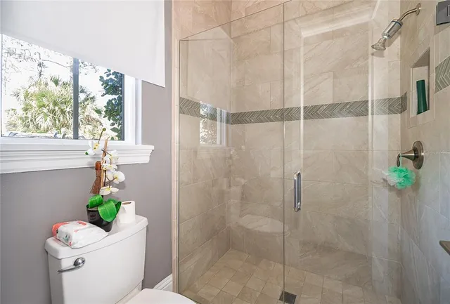 an aerial view of a house with a garden and lake view