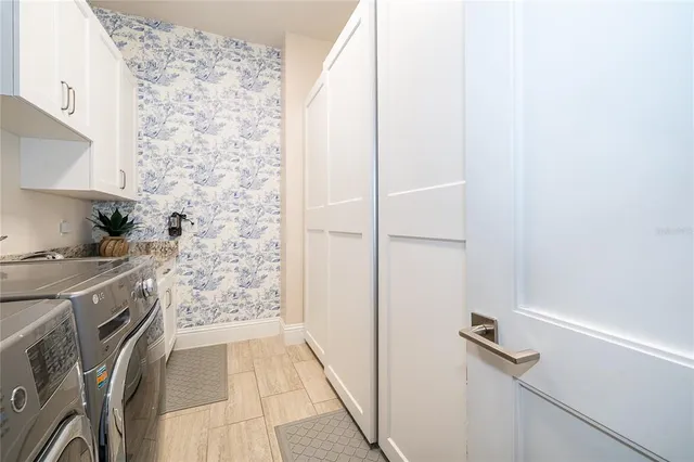 an aerial view of a house with swimming pool and lake view