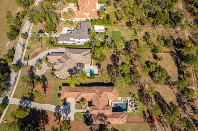 a living room with furniture a dining table and a large window