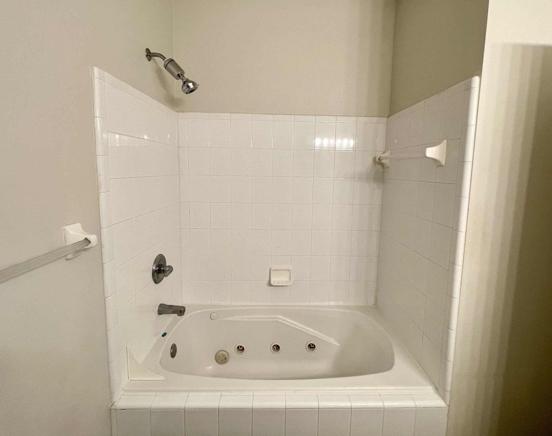 4841 Northwest 75th Road Gainesville, FL 32653 - Photo 11 of 25 a white bath tub sitting next to a shower