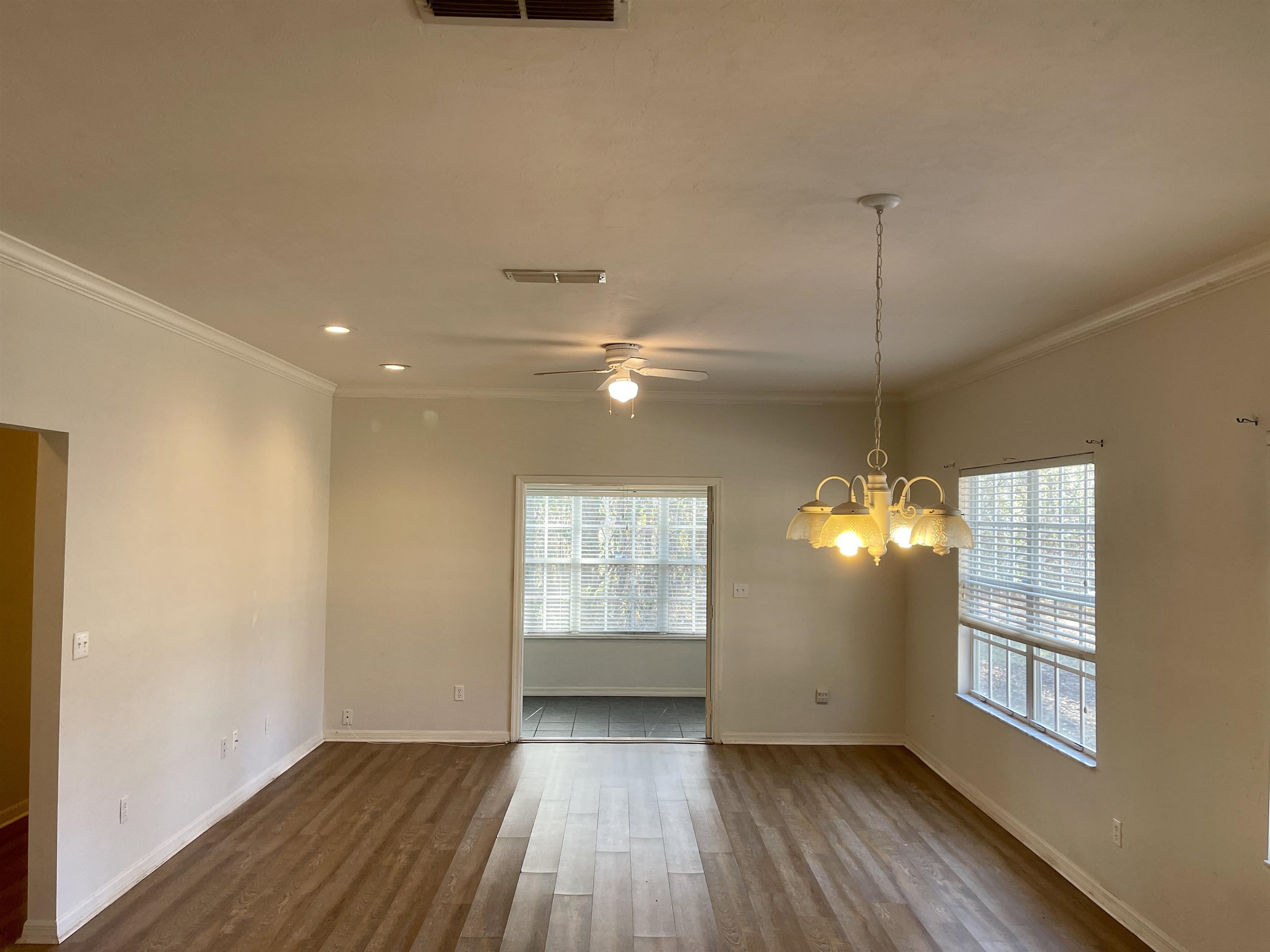 4841 Northwest 75th Road Gainesville, FL 32653 - Photo 7 of 25 a view of an empty room with wooden floor and a window
