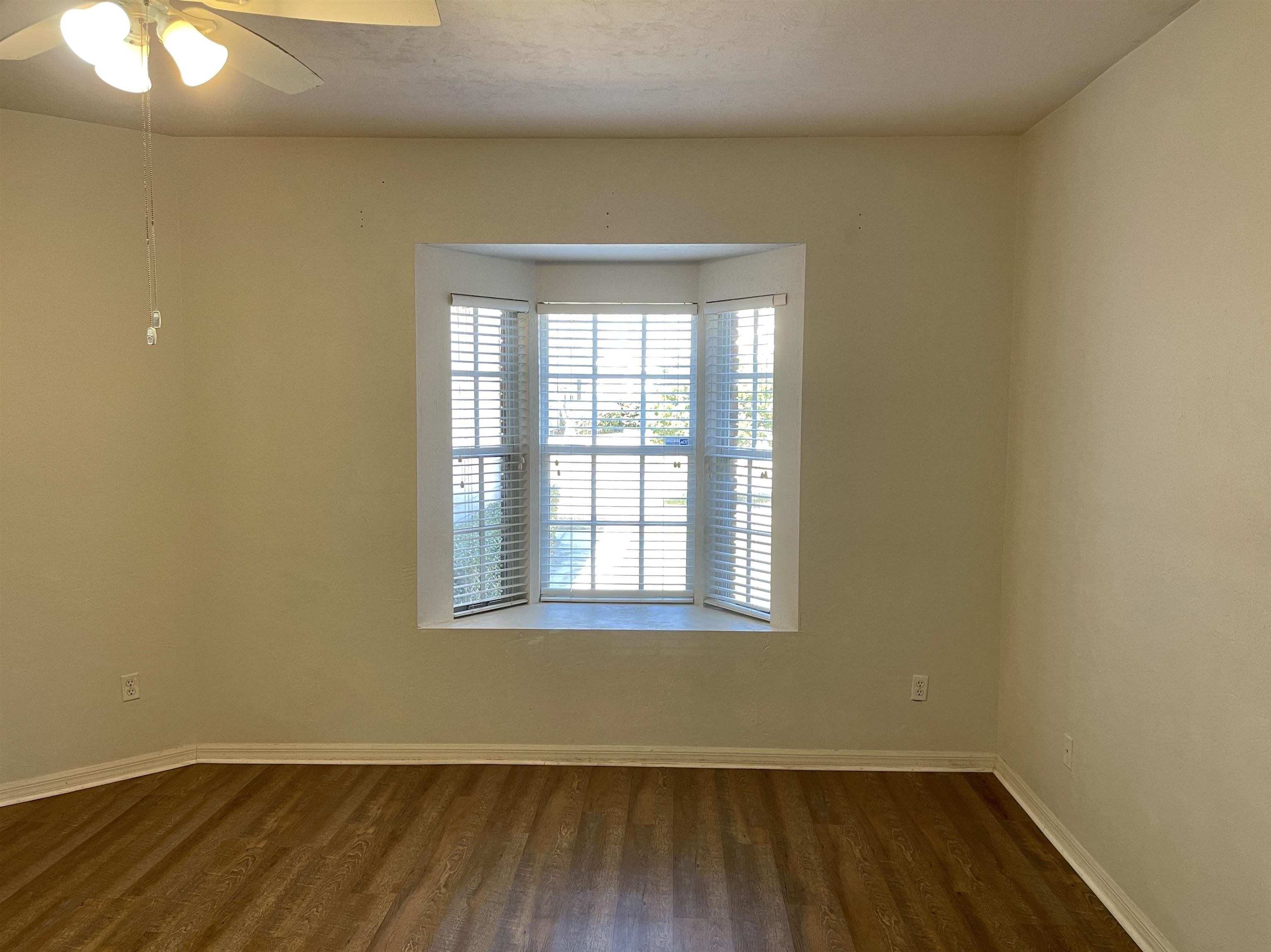 4841 Northwest 75th Road Gainesville, FL 32653 - Photo 9 of 25 an empty room with wooden floor and windows
