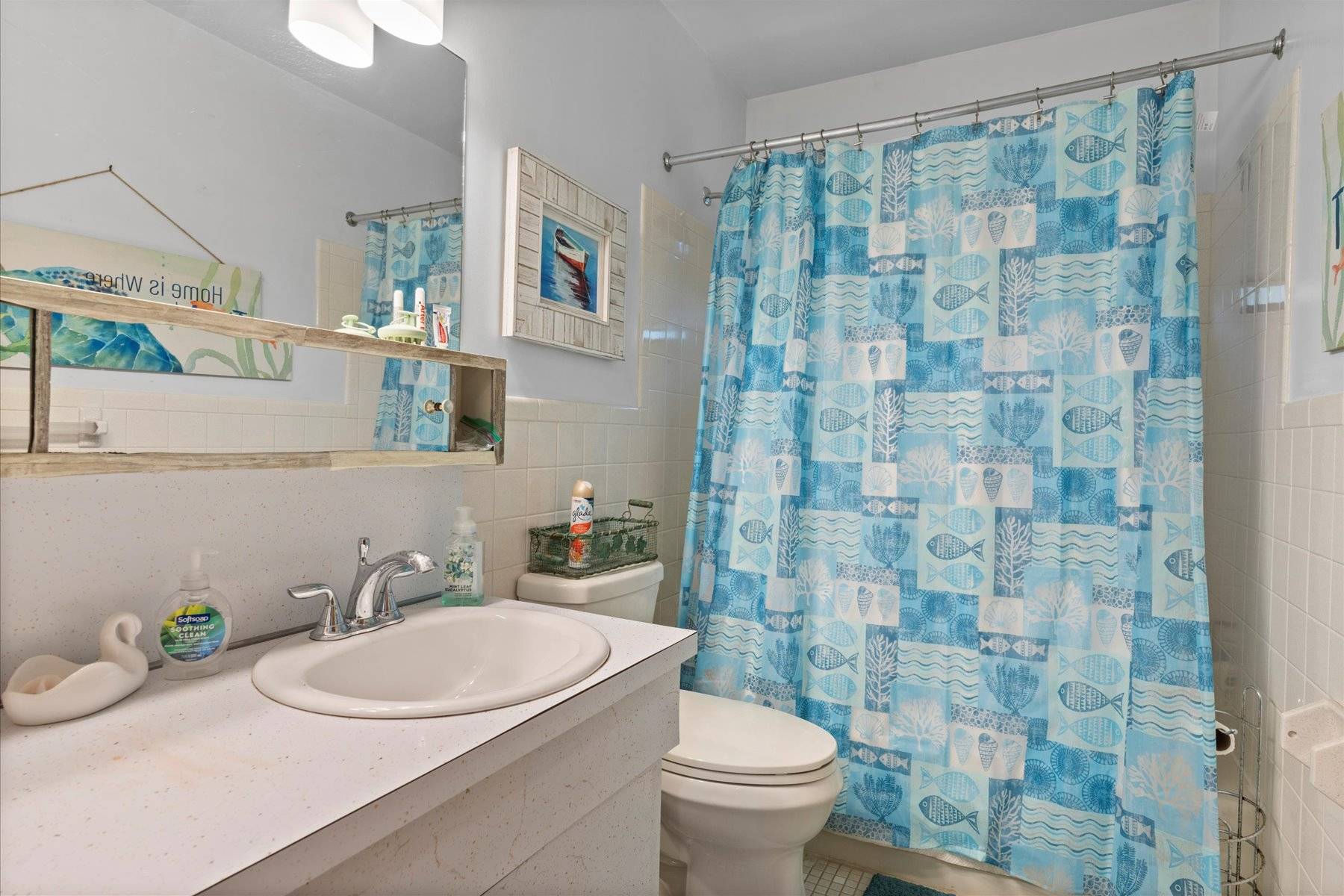 63 Harbor Avenue Sag Harbor, NY 11963 - Photo 8 of 18 a bathroom with a sink a toilet and shower curtain
