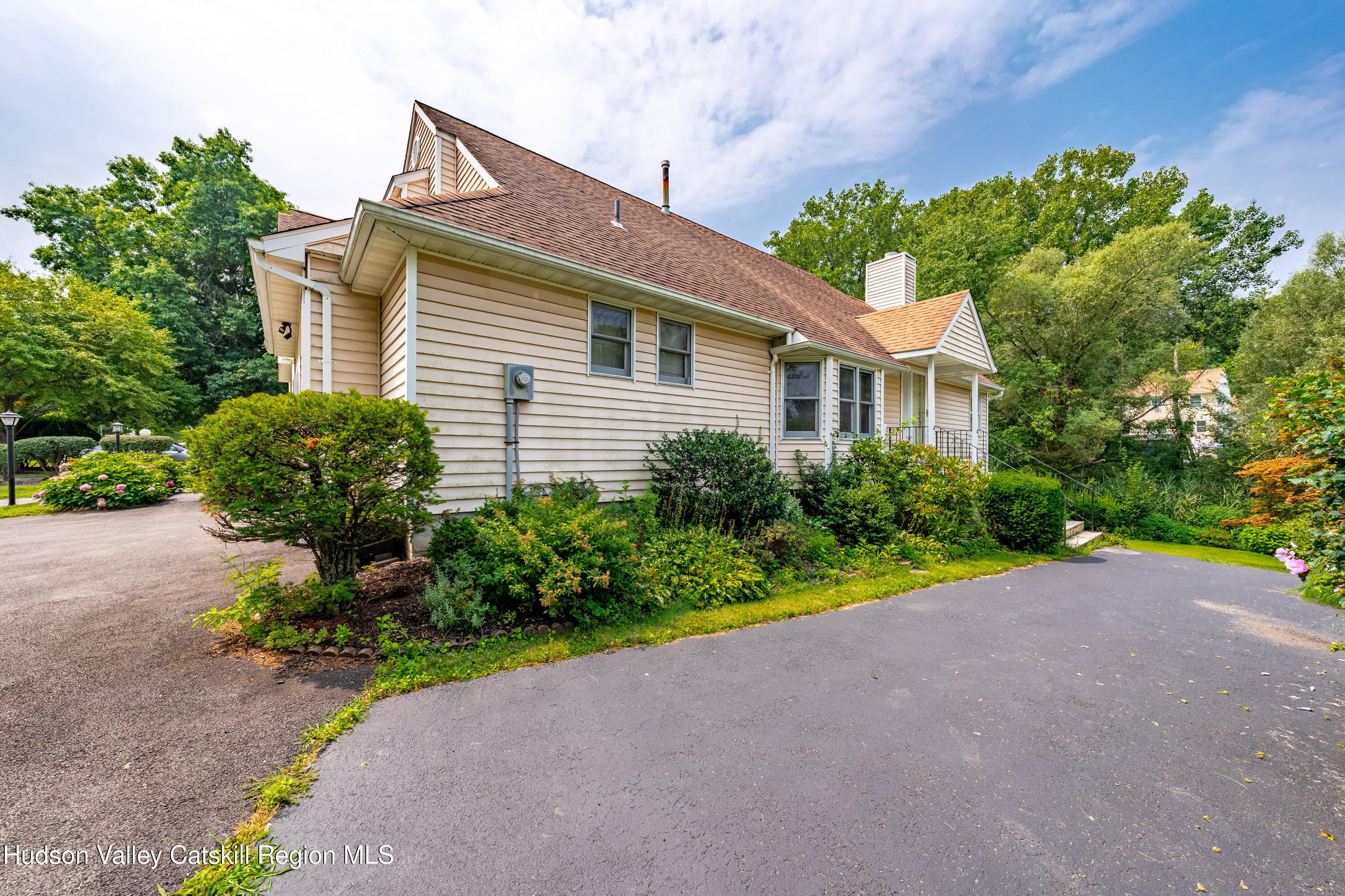 a front view of a house with a yard and outdoor seating