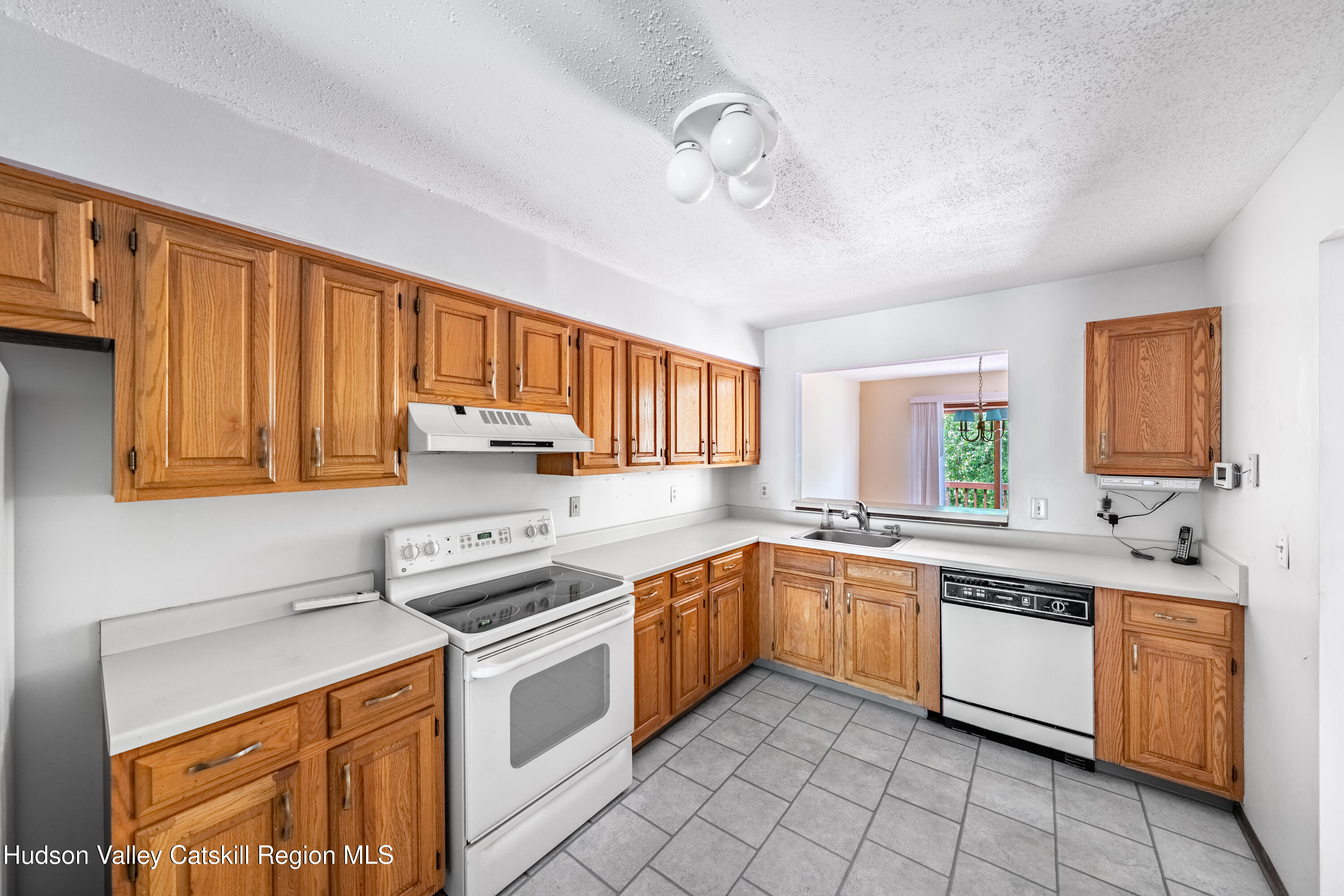 32 Red Maple Road Saugerties, NY 12477 - Photo 13 of 26 a kitchen with a stove sink and cabinets