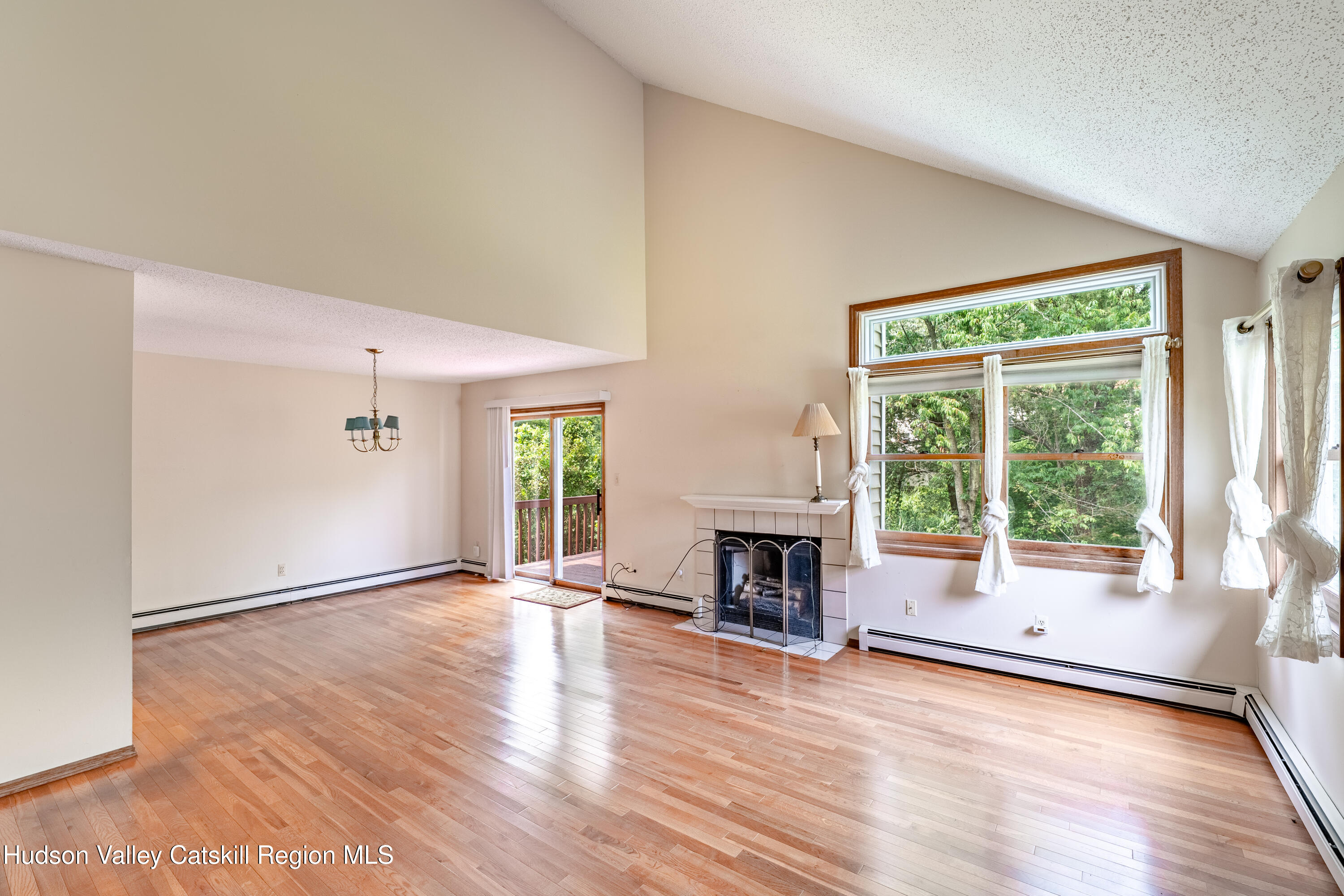 32 Red Maple Road Saugerties, NY 12477 - Photo 14 of 26 an empty room with wooden floor fireplace and windows