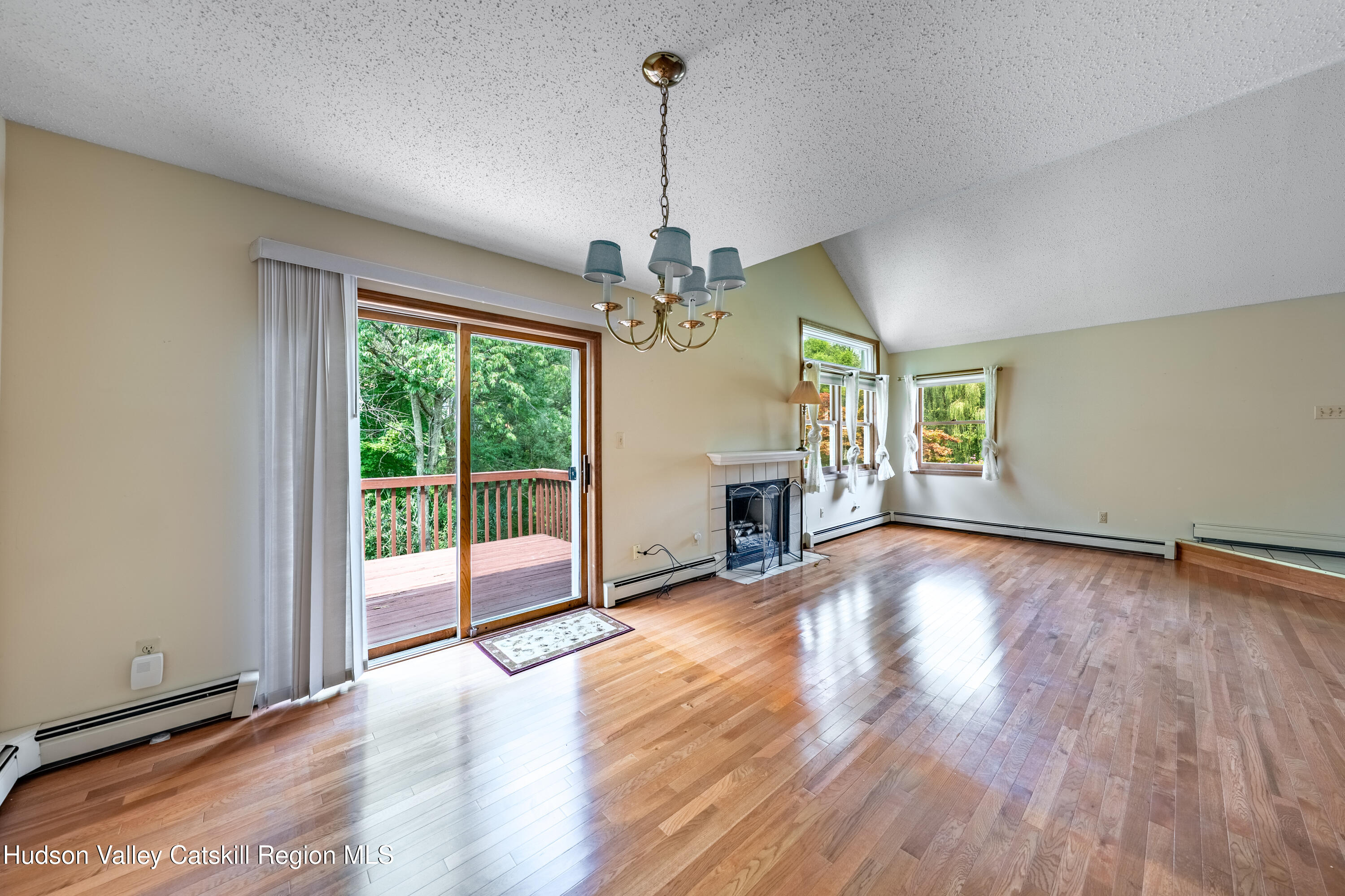 32 Red Maple Road Saugerties, NY 12477 - Photo 15 of 26 a view of a livingroom with wooden floor fireplace and a window