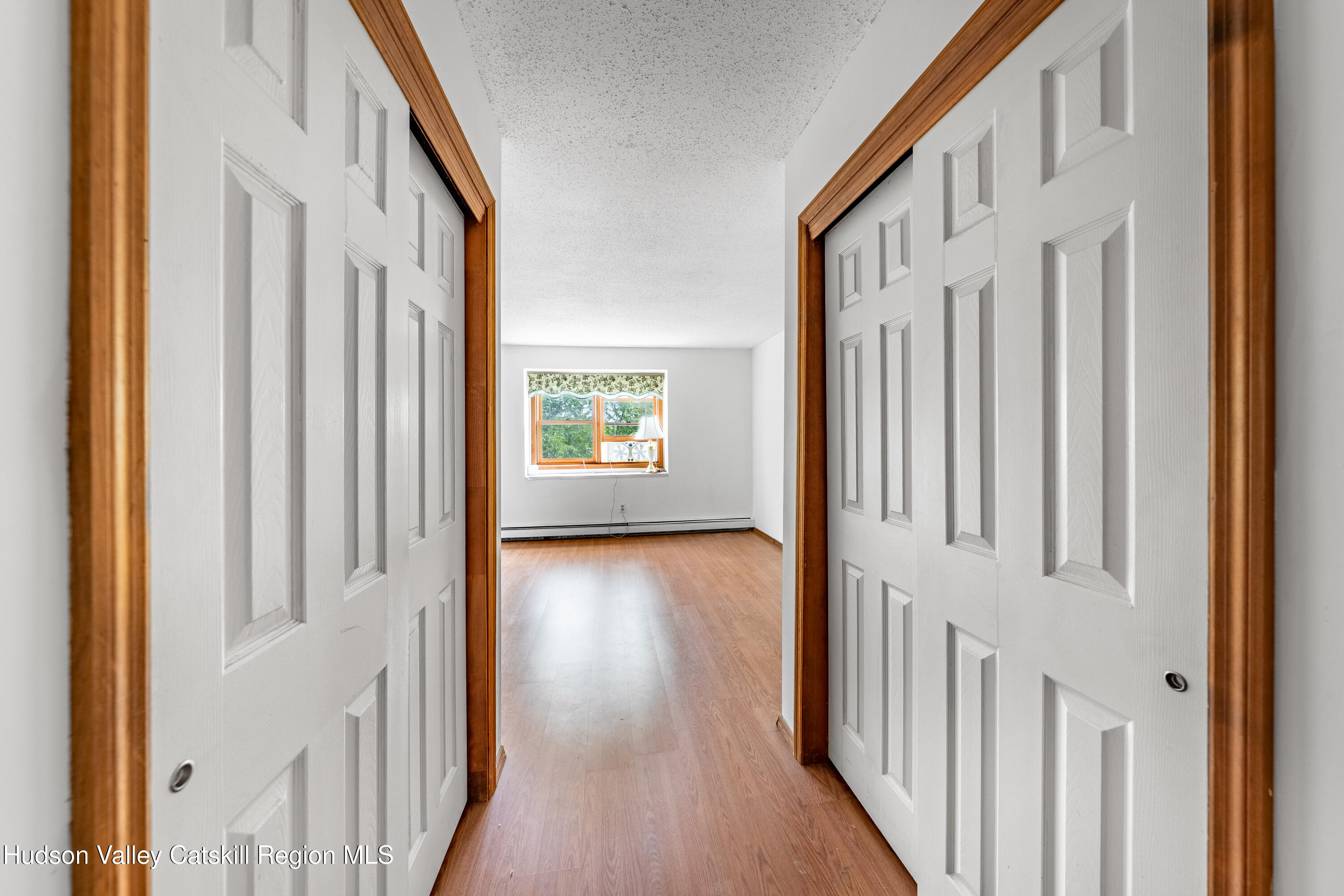 32 Red Maple Road Saugerties, NY 12477 - Photo 19 of 26 a view of a hallway with wooden floor and windows
