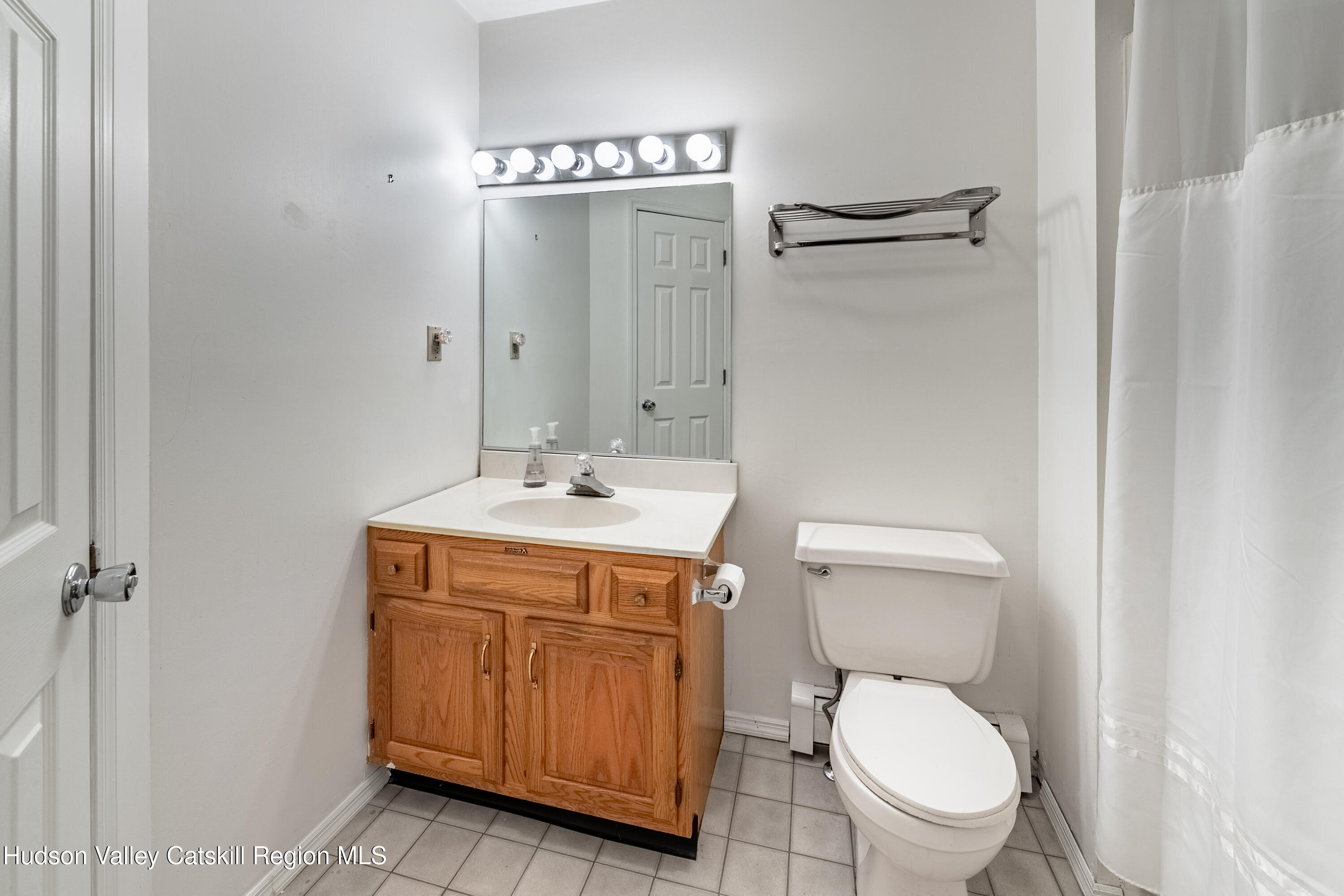 32 Red Maple Road Saugerties, NY 12477 - Photo 21 of 26 a bathroom with a toilet sink vanity and mirror