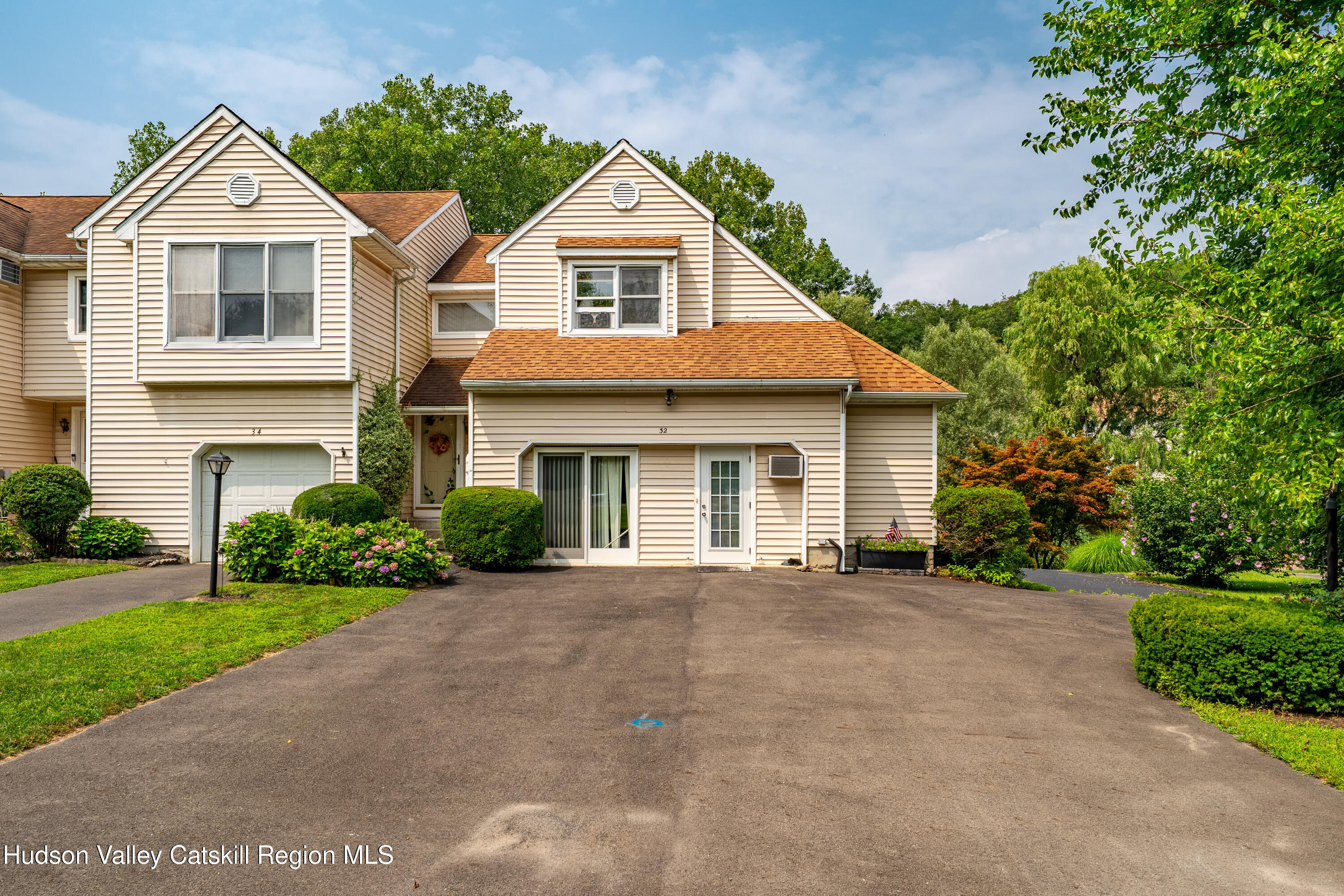32 Red Maple Road Saugerties, NY 12477 - Photo 3 of 26 a front view of a house with a yard and garage