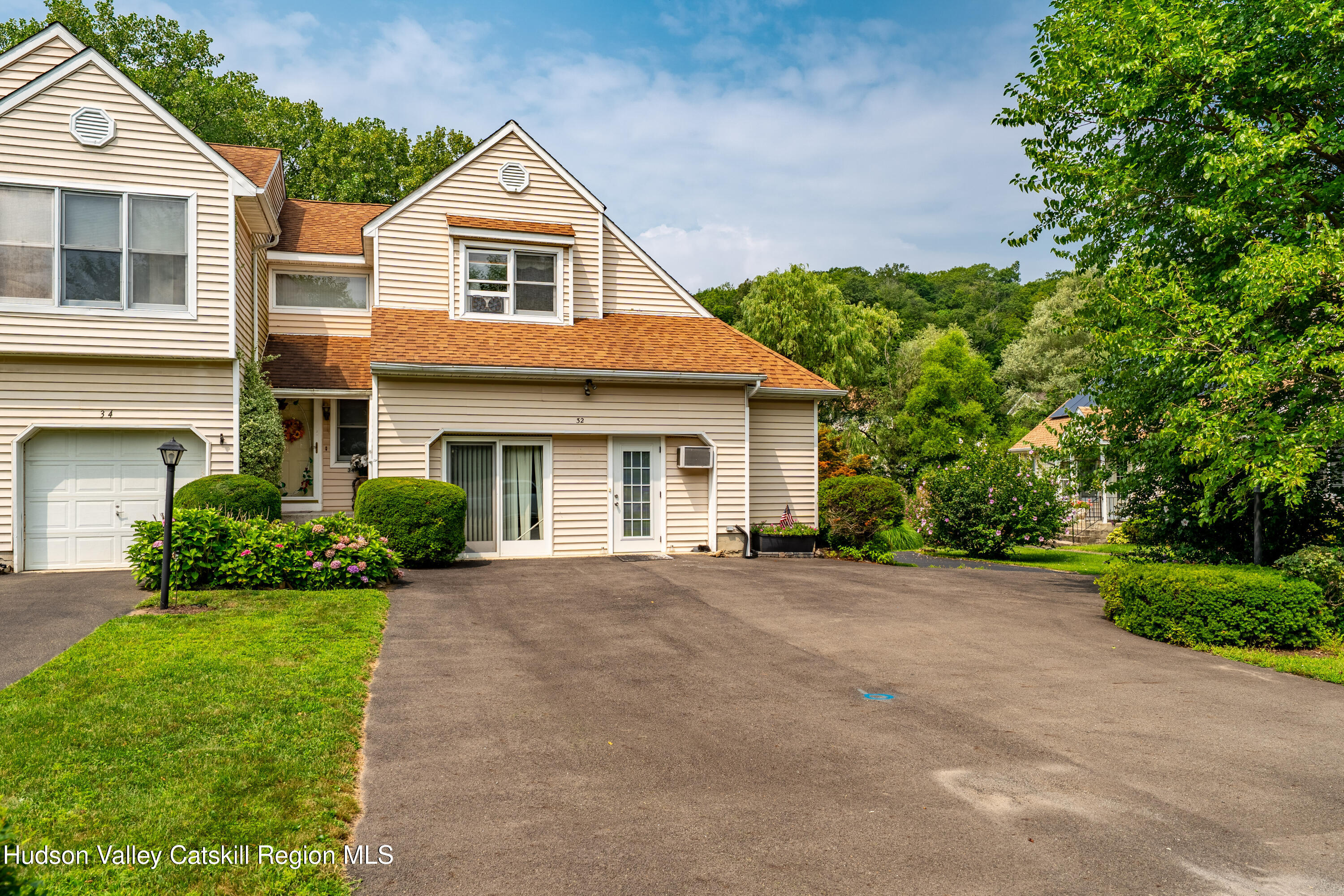 32 Red Maple Road Saugerties, NY 12477 - Photo 4 of 26 a front view of a house with a yard and garage