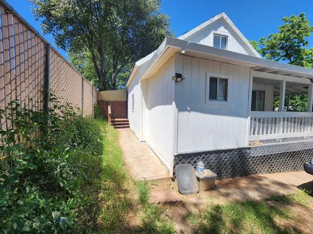 a backyard of a house with outdoor seating