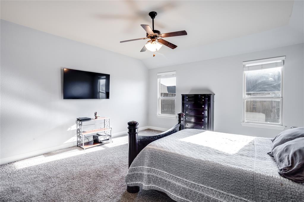 248 Georgetown Drive Forney, TX 75126 - Photo 16 of 39 a bedroom with a bed window and a flat screen tv