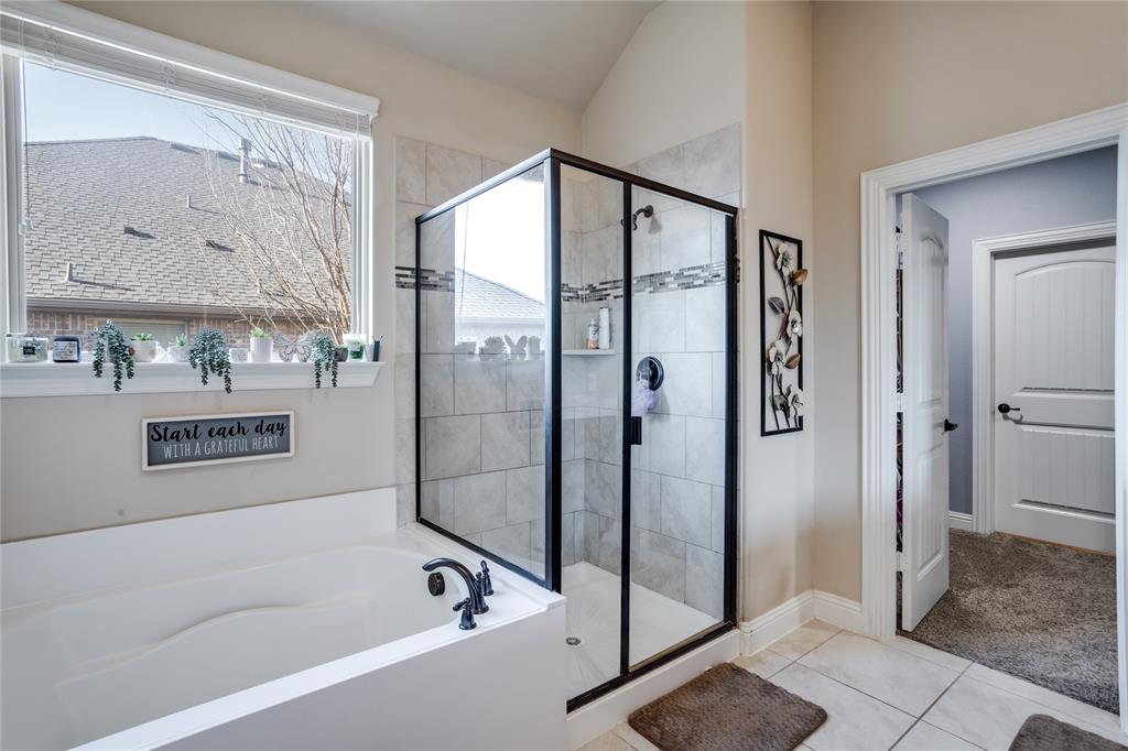 248 Georgetown Drive Forney, TX 75126 - Photo 18 of 39 a bathroom with a bathtub and a shower