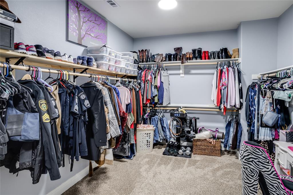 248 Georgetown Drive Forney, TX 75126 - Photo 20 of 39 a view of walk in closet with clothes and shoes
