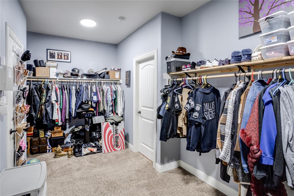 248 Georgetown Drive Forney, TX 75126 - Photo 21 of 39 a view of walk in closet with clothes