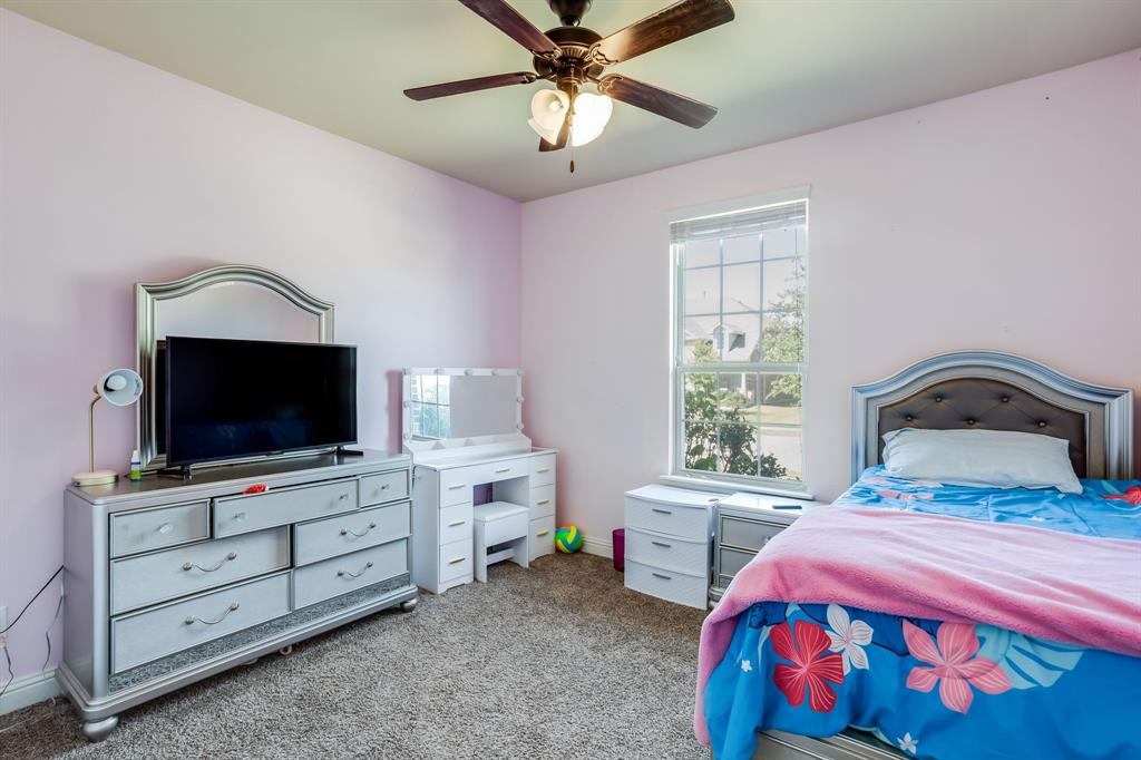 248 Georgetown Drive Forney, TX 75126 - Photo 25 of 39 a bedroom with a bed and a flat screen tv