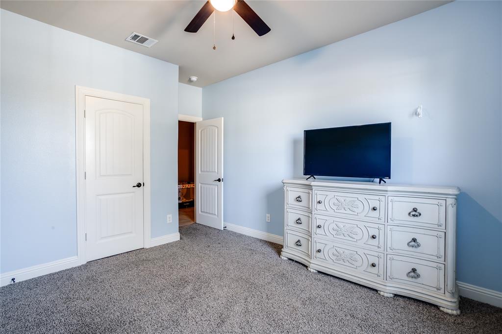 248 Georgetown Drive Forney, TX 75126 - Photo 27 of 39 a room with furniture and flat screen tv