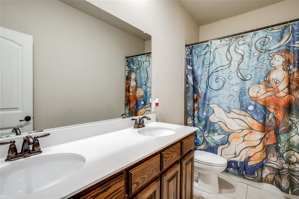 248 Georgetown Drive Forney, TX 75126 - Photo 28 of 39 a bathroom with a sink and a mirror