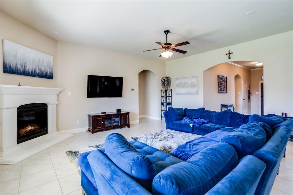 248 Georgetown Drive Forney, TX 75126 - Photo 6 of 39 a living room with furniture a fireplace and a flat screen tv