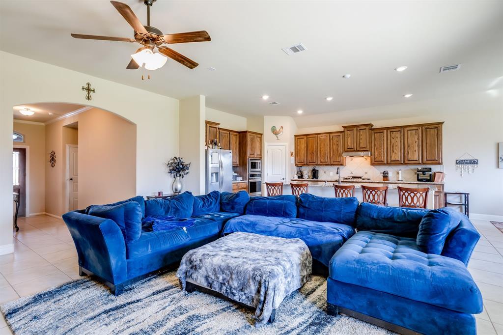248 Georgetown Drive Forney, TX 75126 - Photo 7 of 39 a living room with a couches and kitchen view