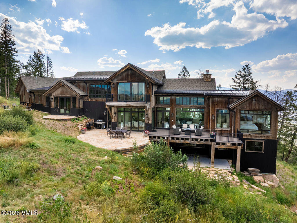 211 Travis Road Wolcott, CO 81655 - Photo 1 of 54 a front view of a house with swimming pool having outdoor seating