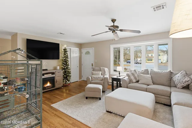 a living room with furniture a fireplace and a flat screen tv