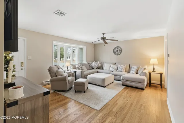 a living room with furniture and wooden floor