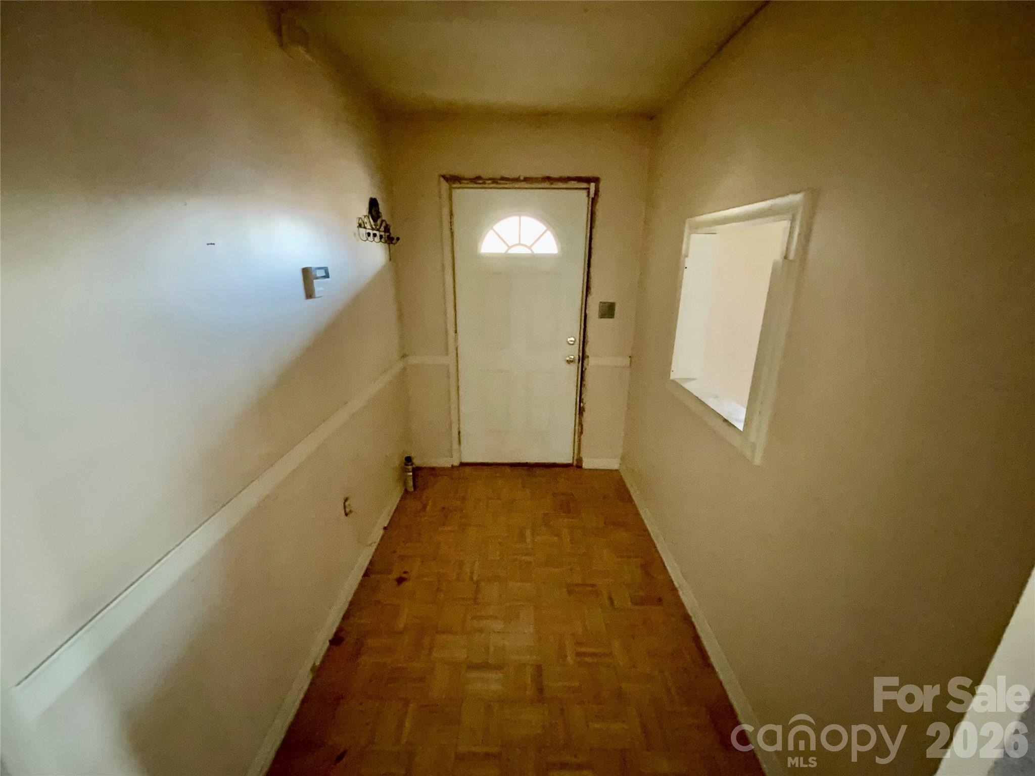 154 Lovelace Road Forest City, NC 28043 - Photo 16 of 17 a view of a hallway with wooden floor and a bathroom