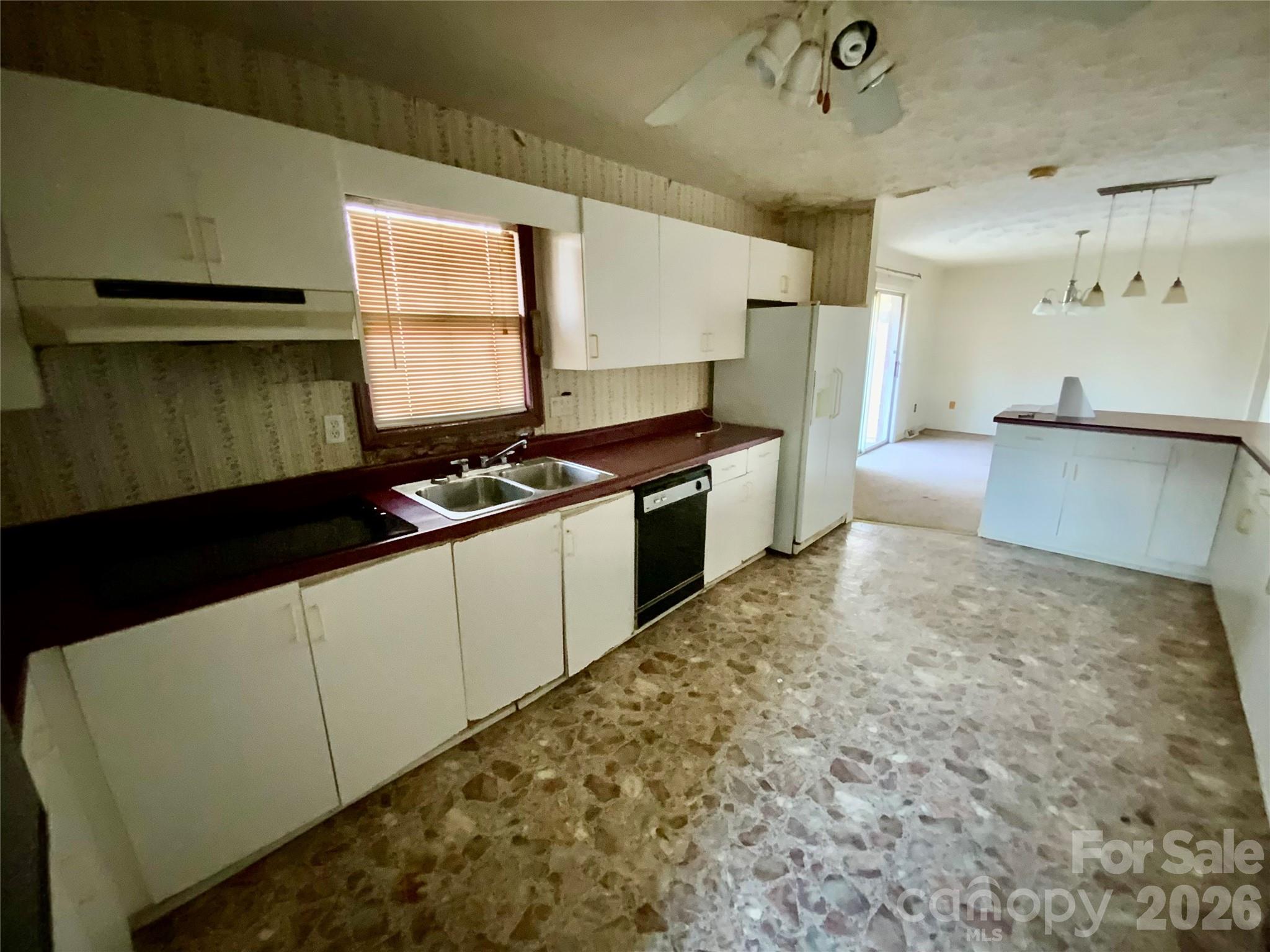 154 Lovelace Road Forest City, NC 28043 - Photo 7 of 17 a kitchen with granite countertop a stove a sink and a refrigerator