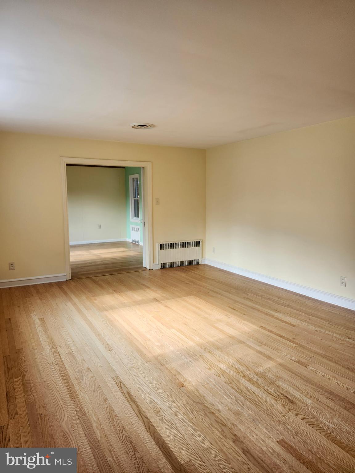 27 South State Street Vineland, NJ 08360 - Photo 11 of 46 an empty room with wooden floor and windows