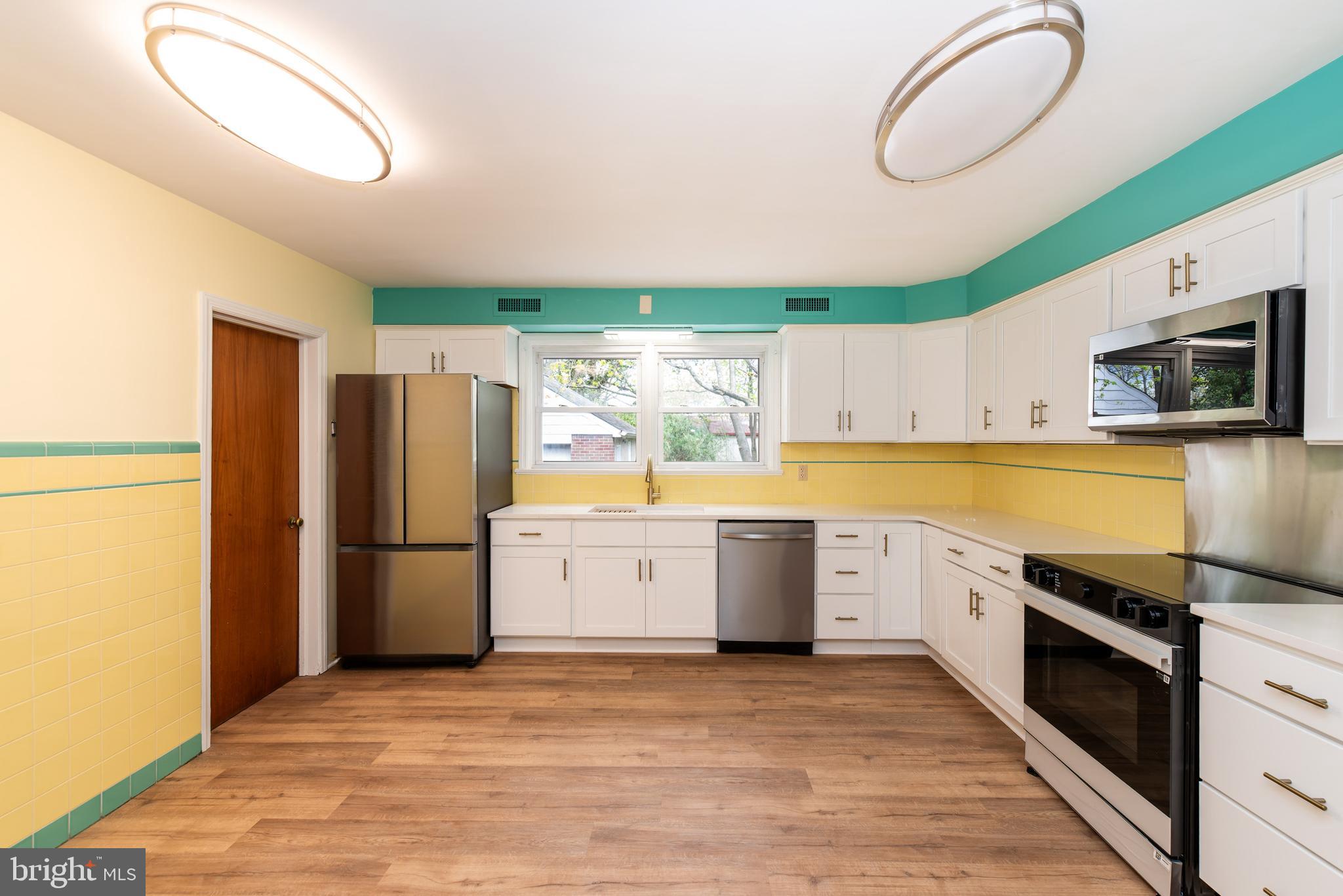 27 South State Street Vineland, NJ 08360 - Photo 19 of 46 a kitchen with a refrigerator and a stove top oven