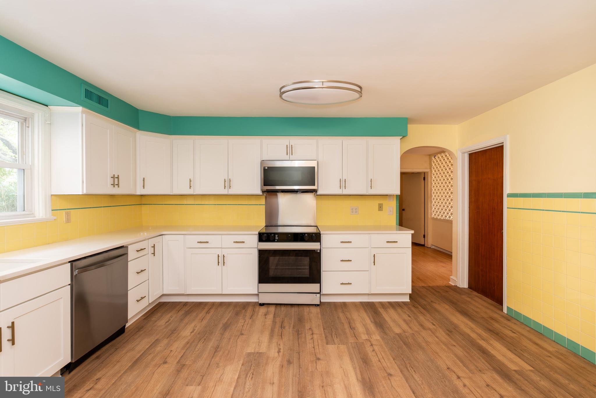 27 South State Street Vineland, NJ 08360 - Photo 21 of 46 a kitchen with stainless steel appliances a stove cabinets and wooden floor